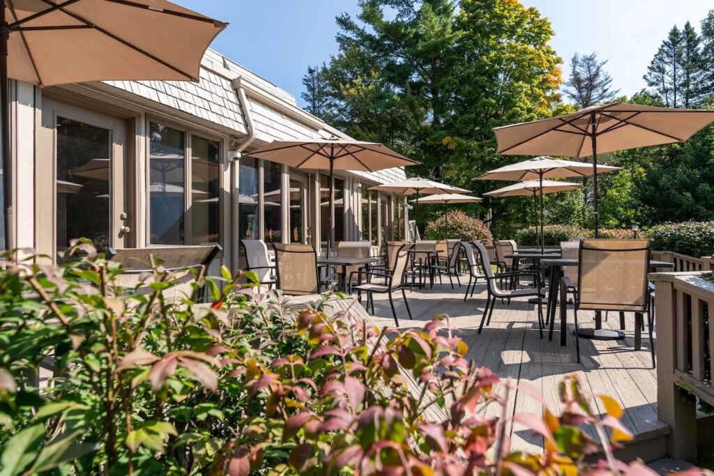 A patio with tables and umbrellas.